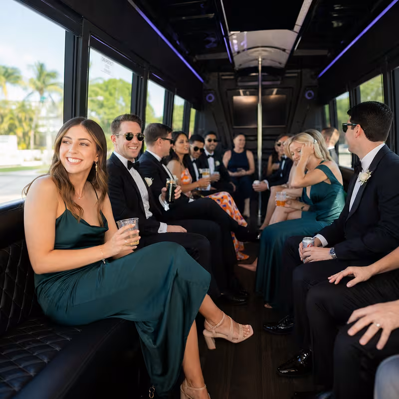 Wedding guests seated inside a Delray Beach party bus