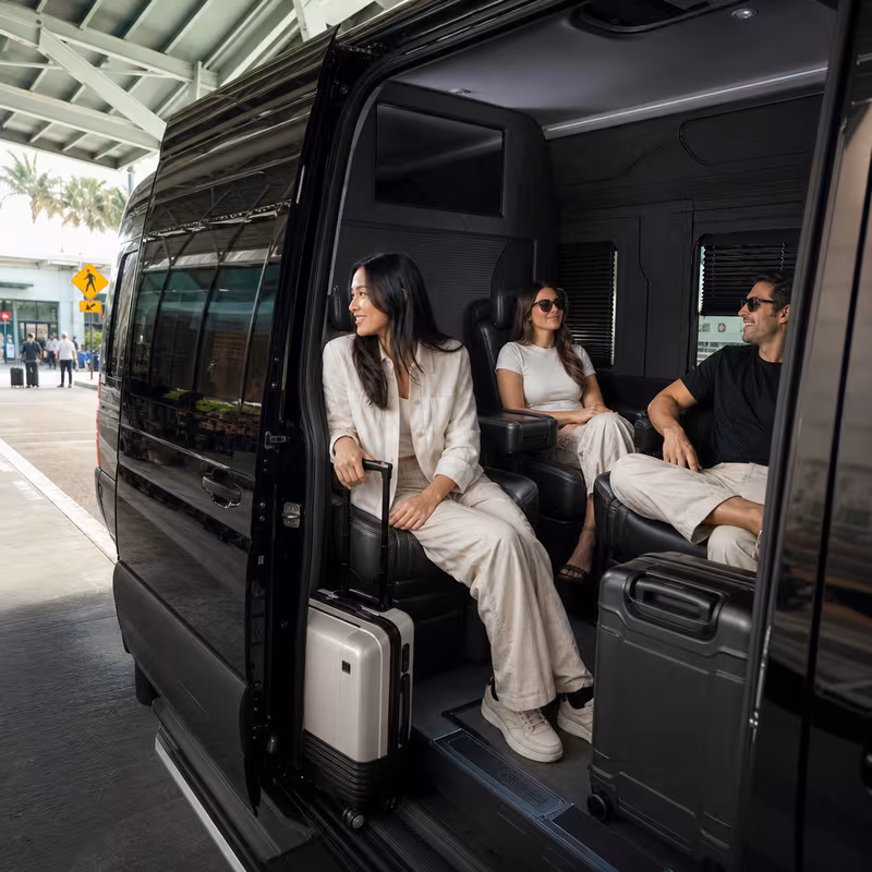 Passengers loading luggage while boarding an Delray Beach group shuttle