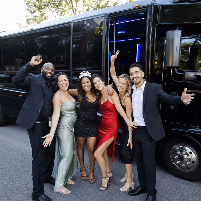 Group boarding a white charter bus for Birthday Transportation transportation in Delray Beach