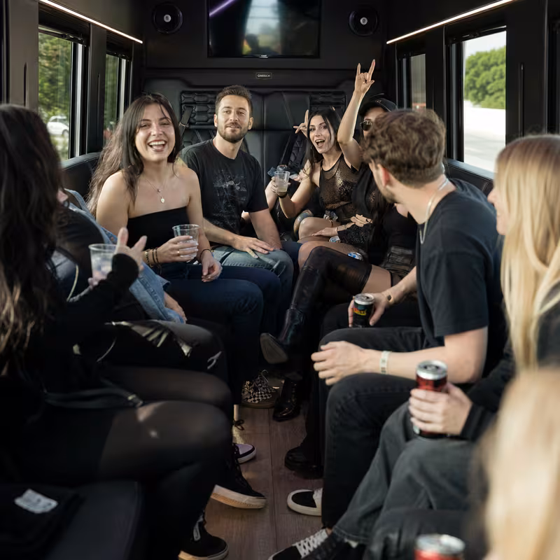 Group boarding a white charter bus for Concert Transportation transportation in Delray Beach