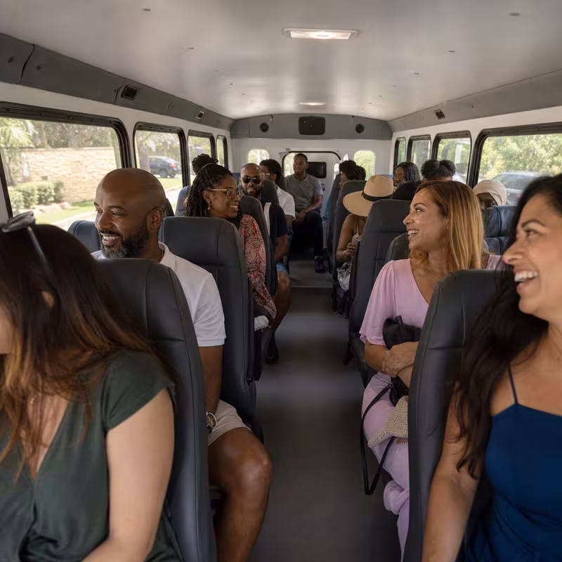 Group boarding a white charter bus for Private Event Transportation transportation in Delray Beach