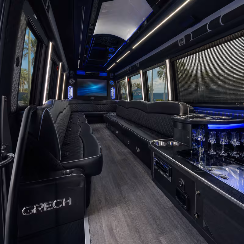 Party bus interior with wraparound leather seating and LED lighting in Delray Beach