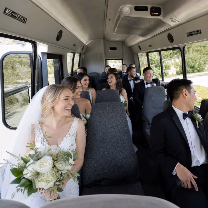 Group boarding a white charter bus for Wedding Transportation transportation in Delray Beach