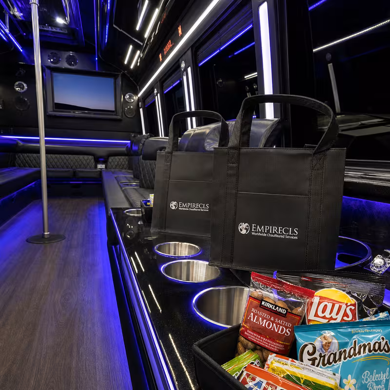 Party bus interior with wraparound leather seating and LED lighting in Delray Beach